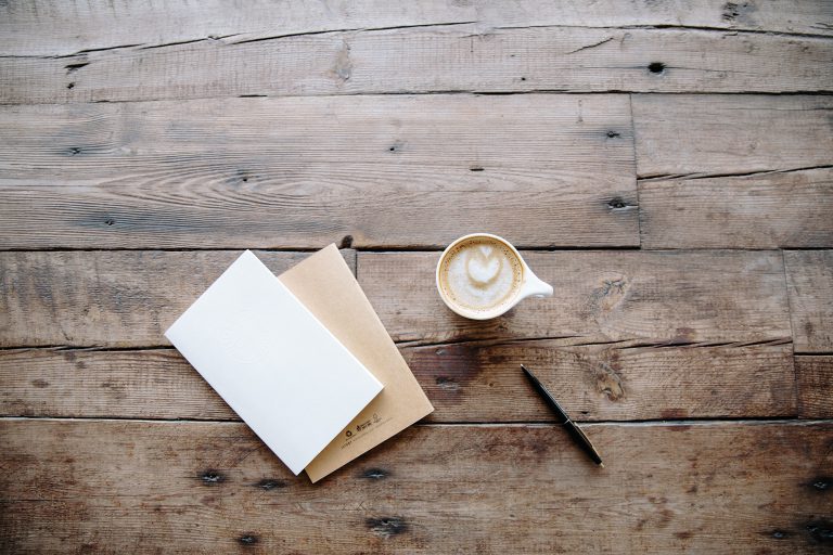 Coffee cup and notepad