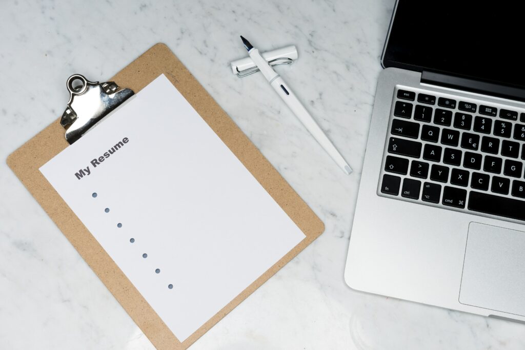 a clipboard and computer on a desk ready to apply for jobs in restructuring and insolvency